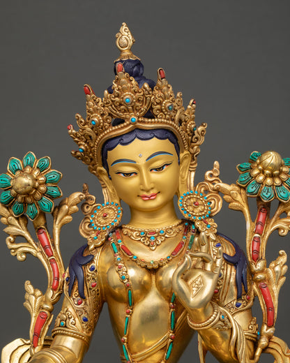 Close-up of Green Tara Statue with intricate gold details and lotus motifs