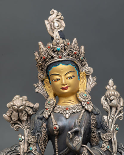 close up of green tara statue with oxidized copper and semi-precious stone details