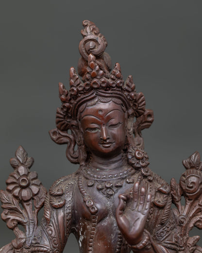 Close up of Green Tara Statue with serene face oxidized copper and hand carved jewelry.