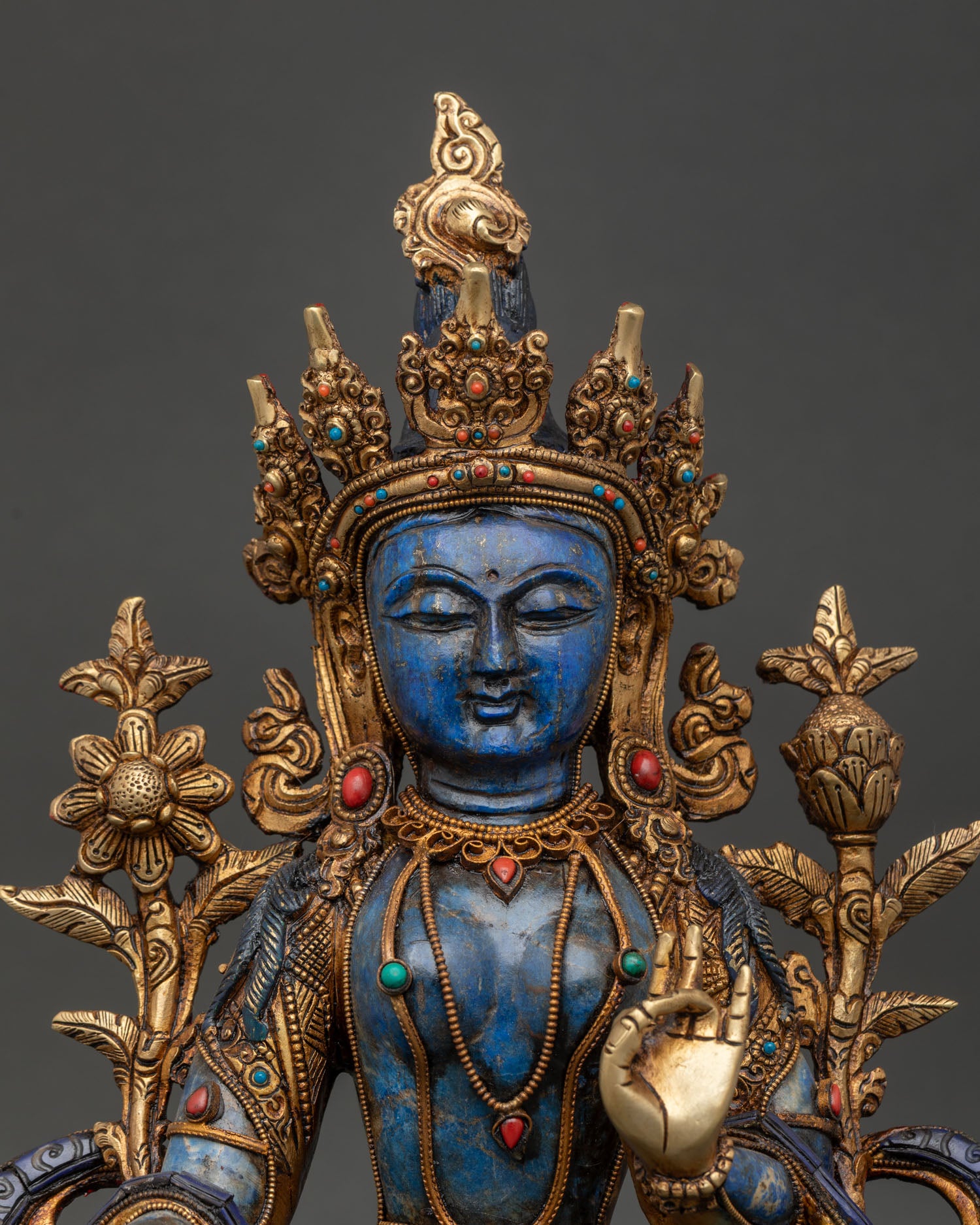Close up of Green Tara statue with turquoise coral and lapis lazuli stone inlay details
