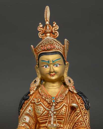 Close up of Guru Padmasambhava statue with gold painted face and semi precious stone ornaments