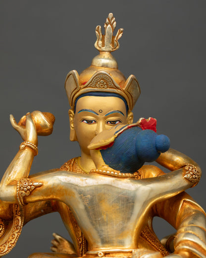 close up of guru padmasambhava yab yum statue with intricate gold gilded details