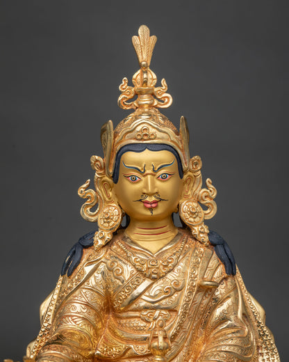 Close-up of Guru Rinpoche face with blue brows, painted mustache, and rosette earrings