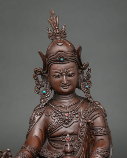 Close-up of Guru Rinpoche statue’s face and lotus hat with inlaid stones