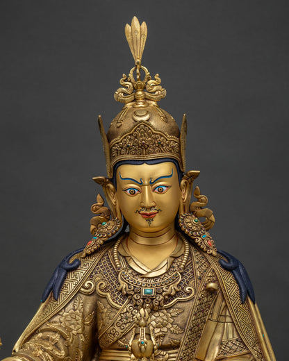 Close-up of Guru Rinpoche statue holding vajra and kapala skull cup