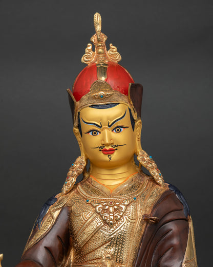 Close-up of Guru Rinpoche Statue showing gold-painted face, semi-wrathful expression, and ornaments.