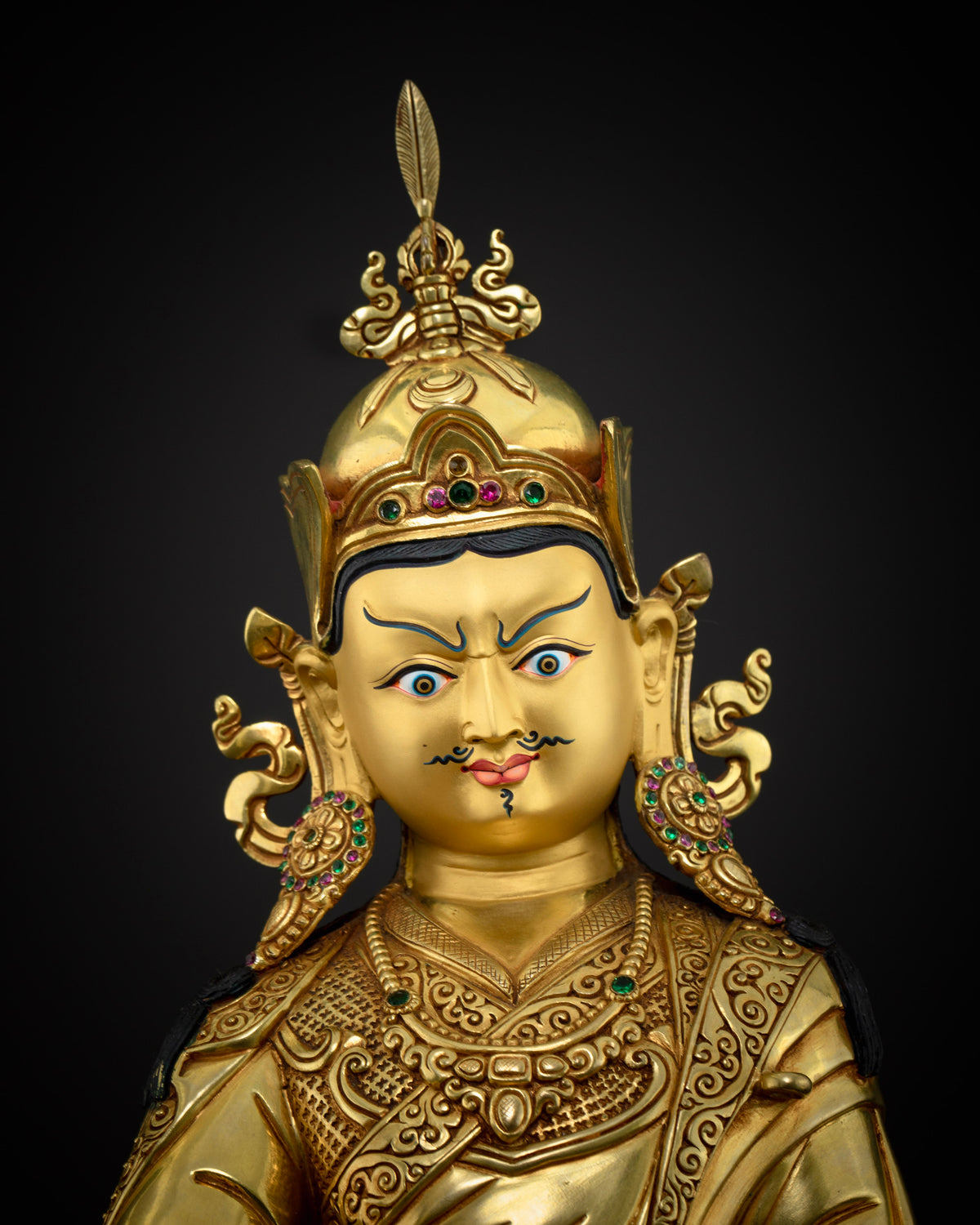 Close up of Guru Rinpoche statue showing hand cast copper alloy and gold fire gilding from Nepal