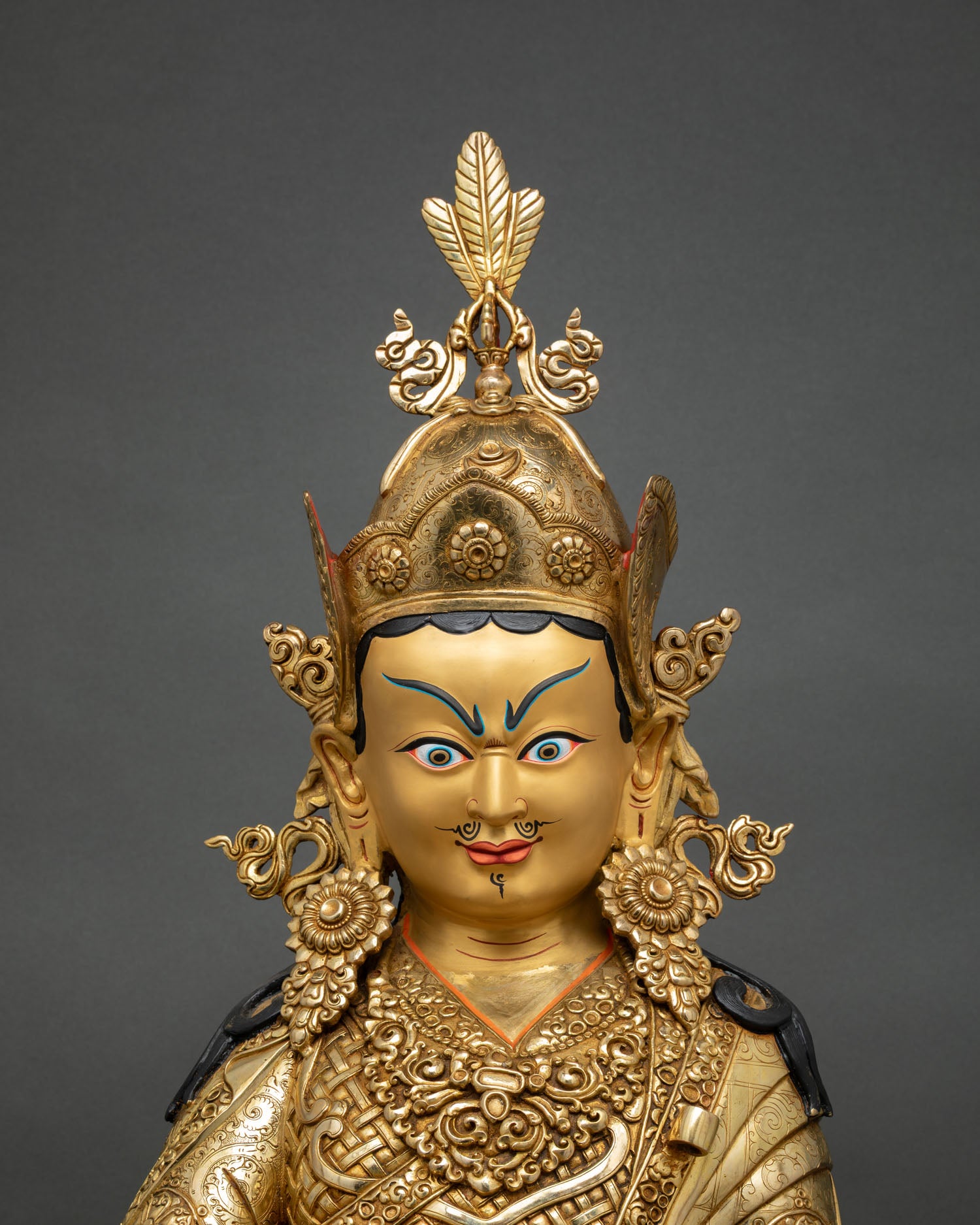 close up of guru rinpoche statue showing lost wax craftsmanship, detailed vajra and skull cup, nepalese buddhist art