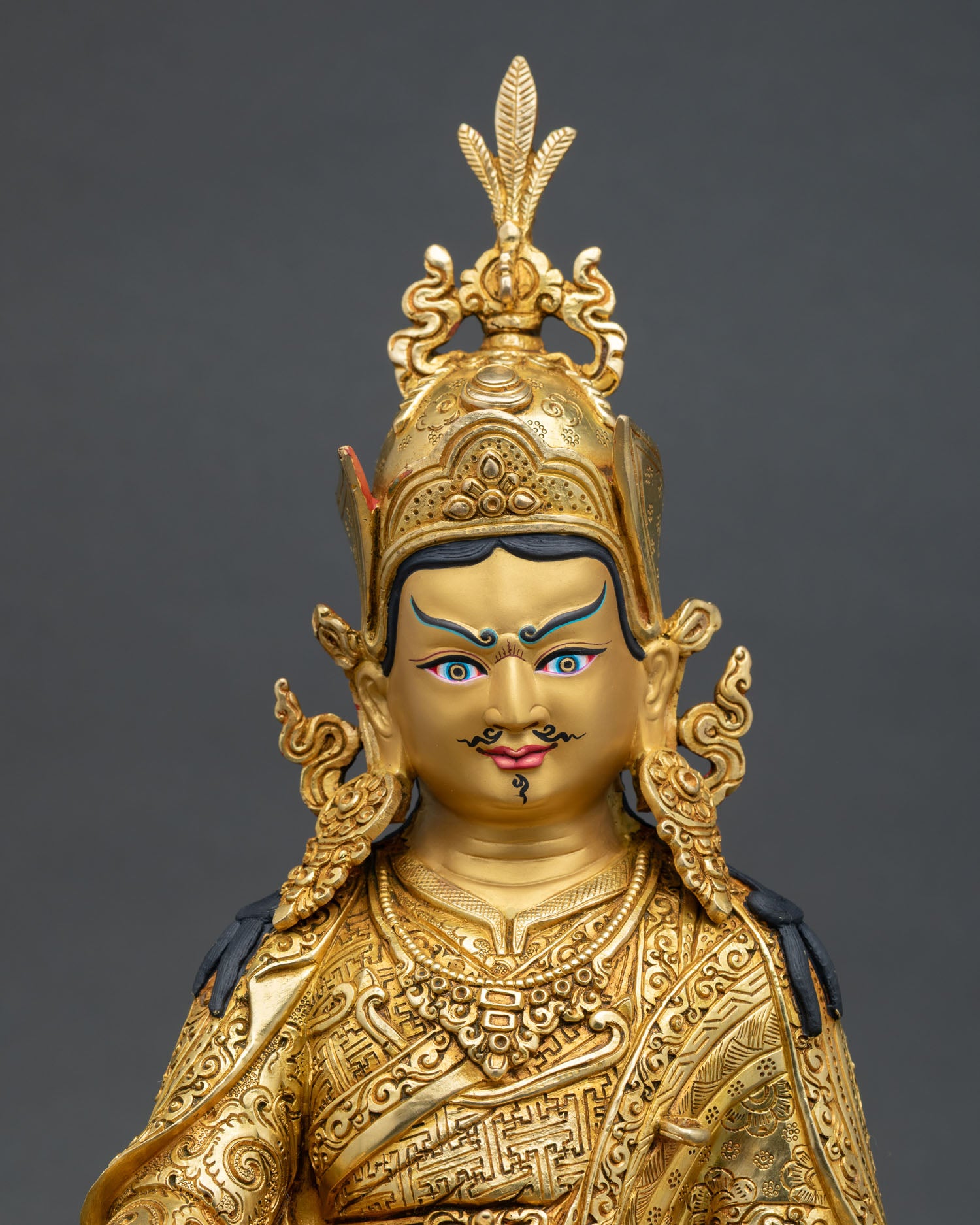 Close-Up of Guru Rinpoche Statue with Hand-Carved Robes and Lotus Throne Details