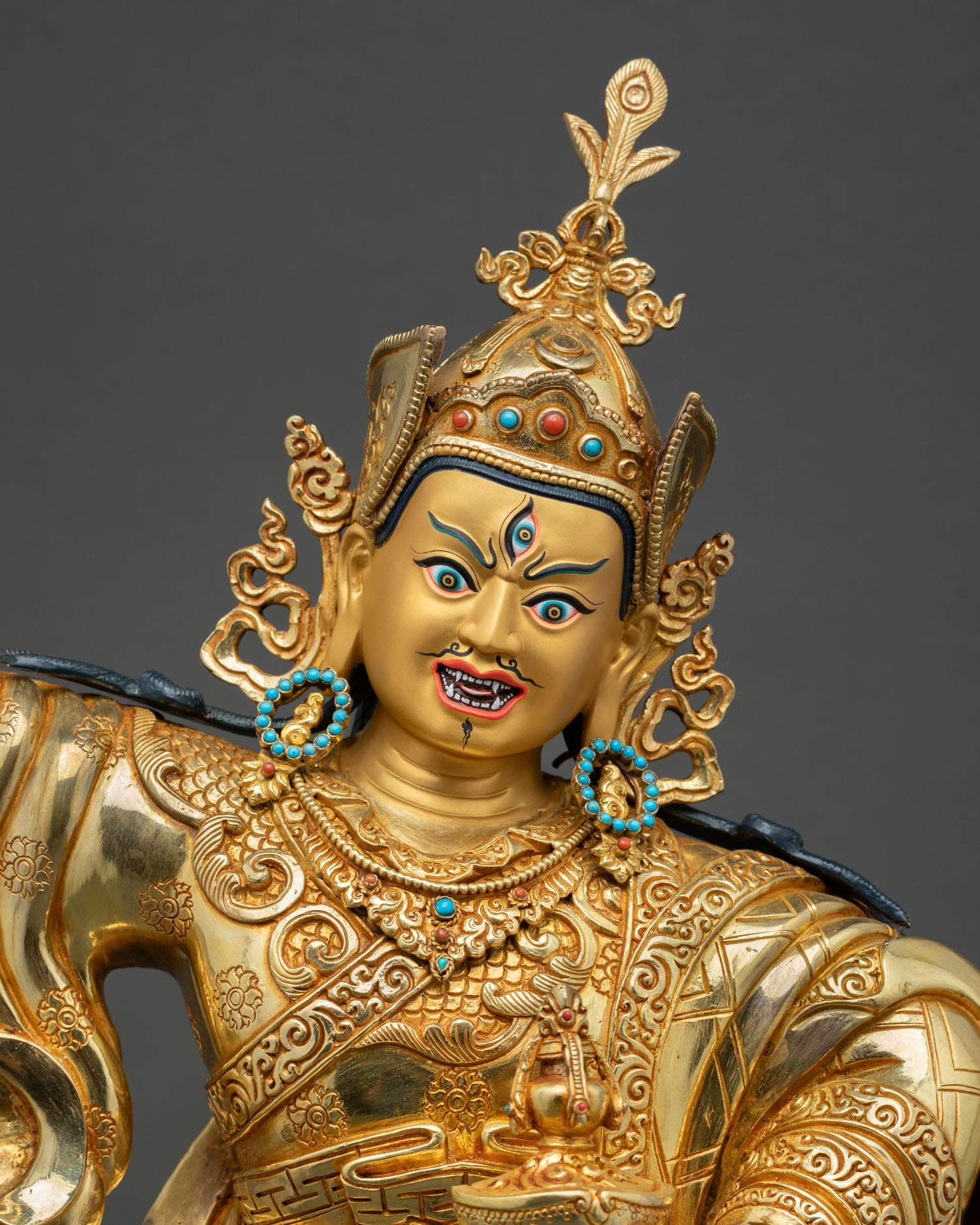 Close-up of Guru Rinpoche statue with lotus crown and semi-wrathful expression