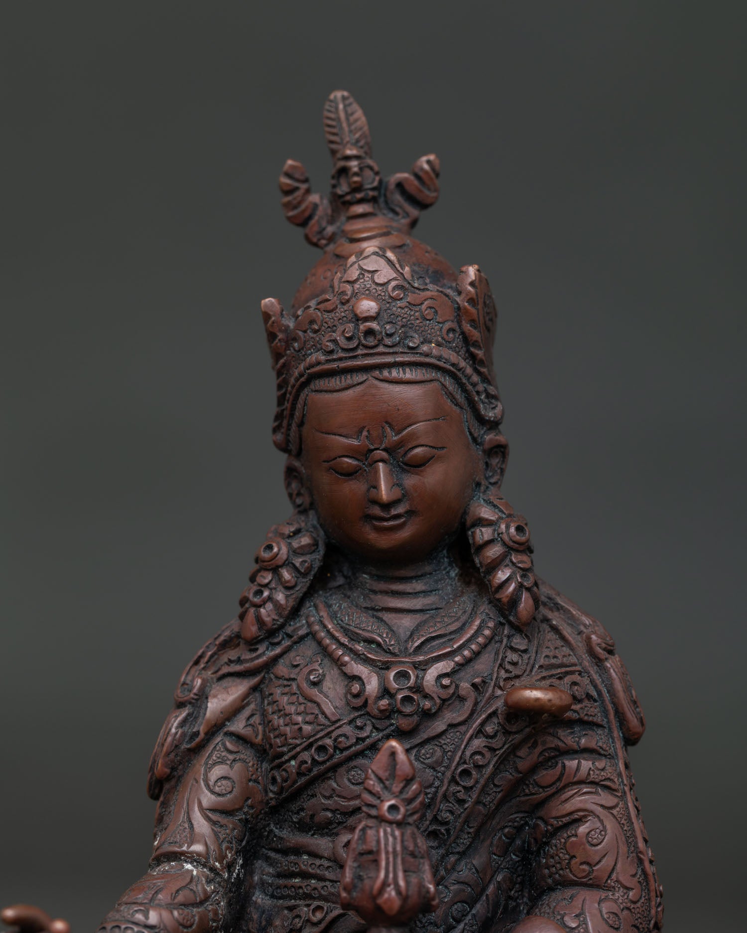 Close Up of Guru Rinpoche Statue with Lotus Hat Vajra and Hand Carved Silk Garment.