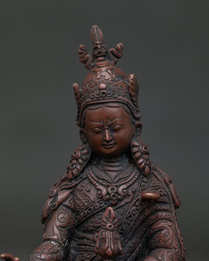 Close Up of Guru Rinpoche Statue with Lotus Hat Vajra and Hand Carved Silk Garment.