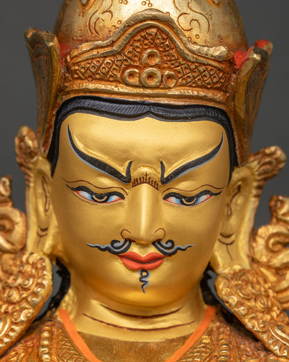 Close-up of Guru Rinpoche Tsokye Dorje statue hand-painted face and gilded crown