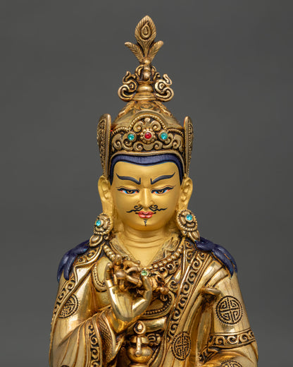 Close up of Guru Tsokye Dorje statue, featuring gold painted face and intricate Buddhist ornaments