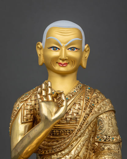 Close-up of Gyaltsab Je face with white hair, raised right hand and turquoise inlay on robe