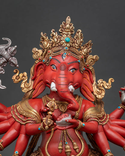 Close-up of hand-carved Ganesha statue with gold gilded crown and jewelry