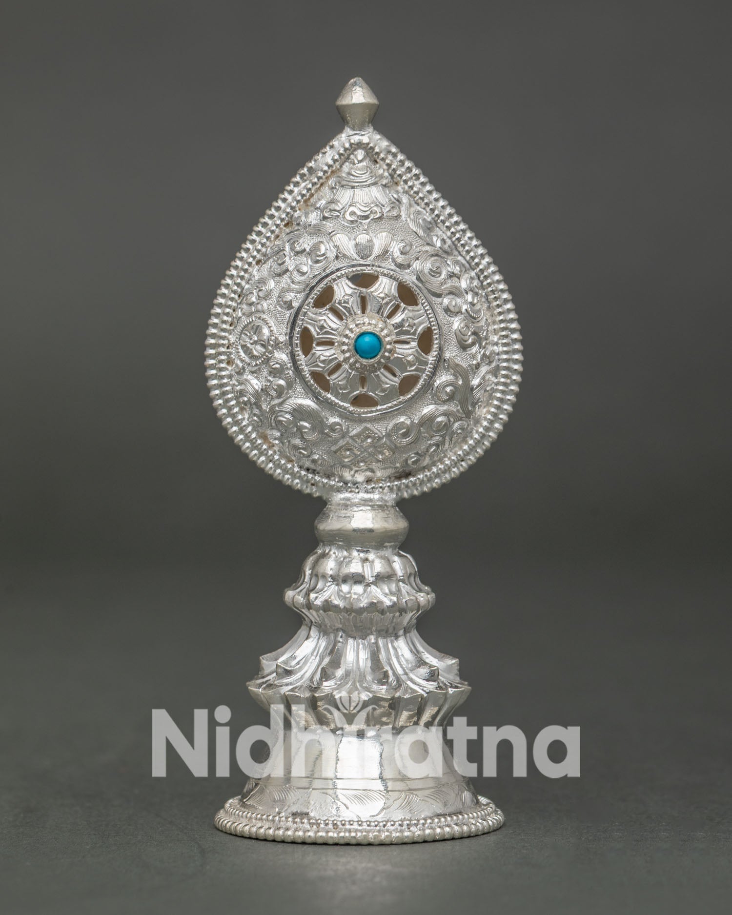 Close-Up of Hand-Carved Silver Norbu Finial with Turquoise Stone and Openwork Dharma Wheel