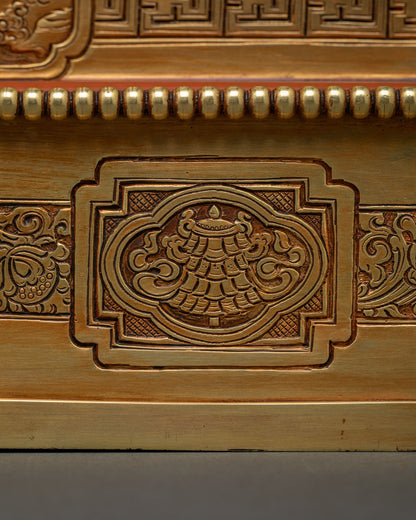 Close-up of hand-chased floral medallion carving on Dzambhala Statue throne