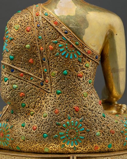 Close-up of hand chased repoussé pattern on Buddha statue's robe