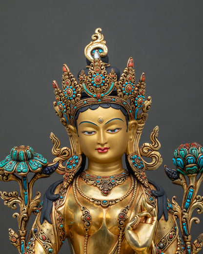 Close up of handcrafted Green Tara statue with jeweled crown and gold fire-gilded copper body