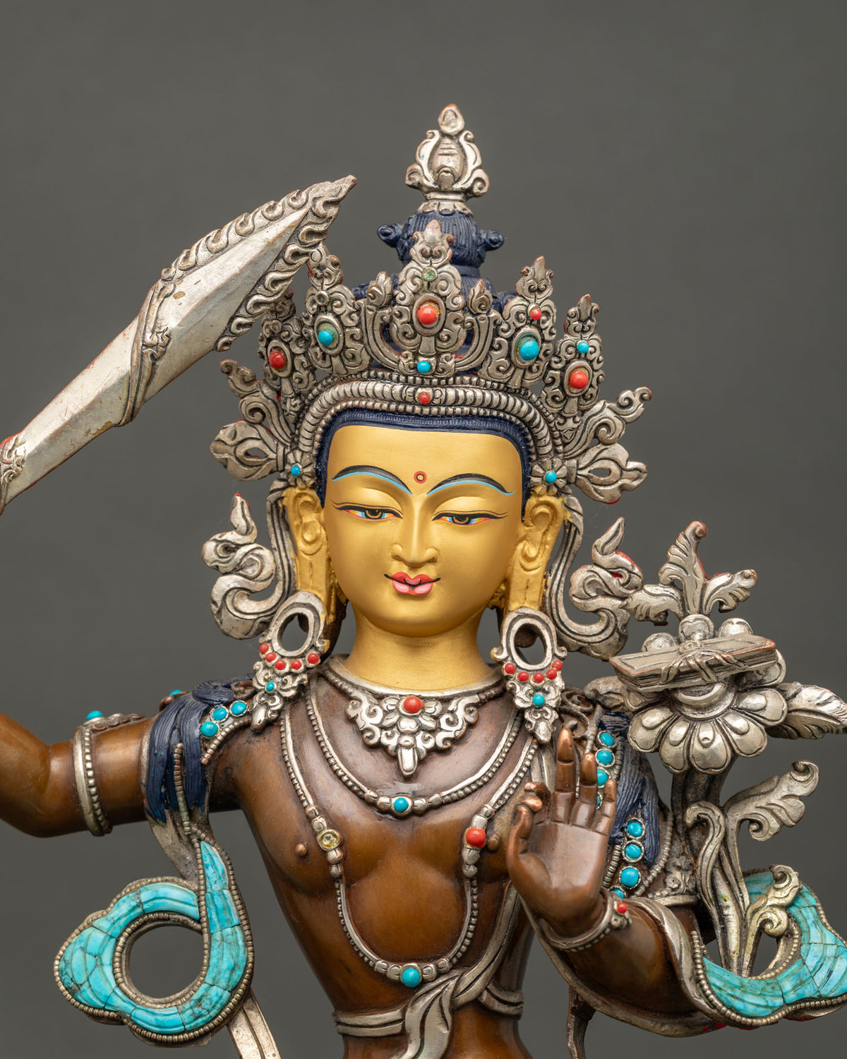 Close Up of Handcrafted Manjushri Statue with Silver Plated Crown and Turquoise Inlay
