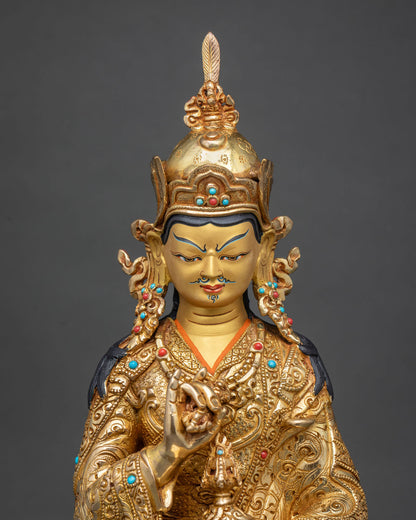 Close up of handcrafted Tsokye Dorje statue with fire-gilded robe and turquoise, coral inlay