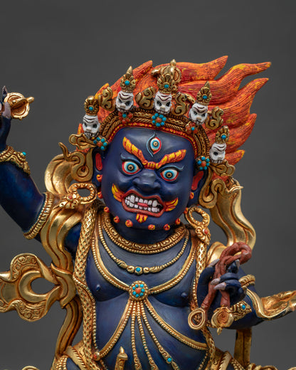 Close-up of handcrafted Vajrapani Buddhist statue with gold gilding and gemstone details