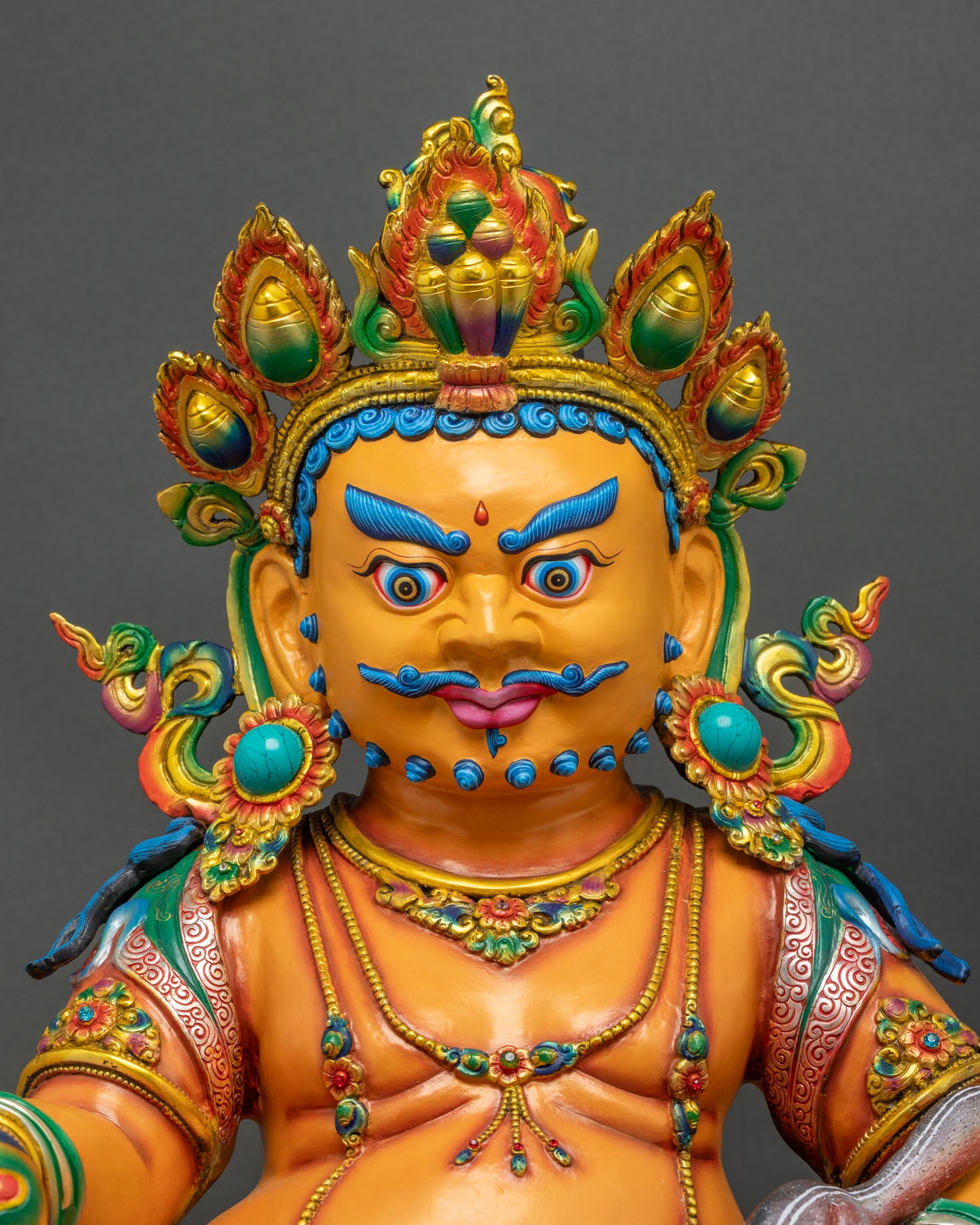 Close Up of Handcrafted Yellow Dzambhala Statue with Gold Gilded Crown and Turquoise Stones
