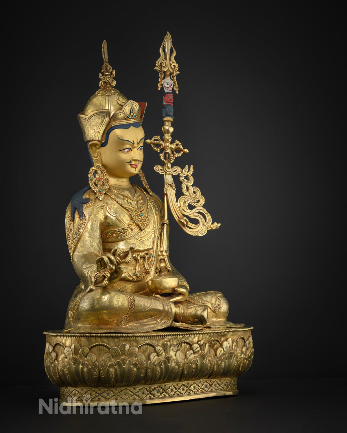Close up of handmade Guru Rinpoche statue showing layered 24K gold fire-gilding on solid copper