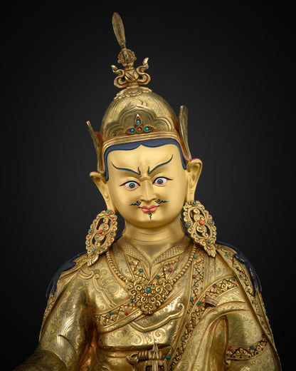 Close up of handmade Guru Rinpoche statue showing layered 24K gold fire-gilding on solid copper