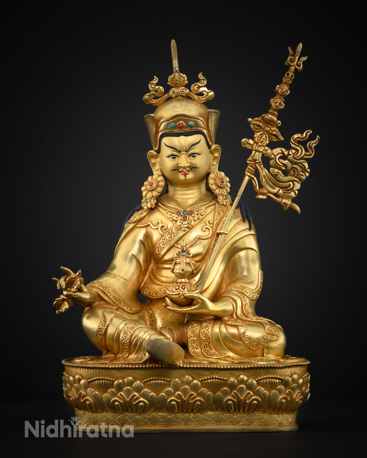 Close up of handmade Guru Rinpoche statue showing triple-layer 24K gold fire-gilding on copper alloy