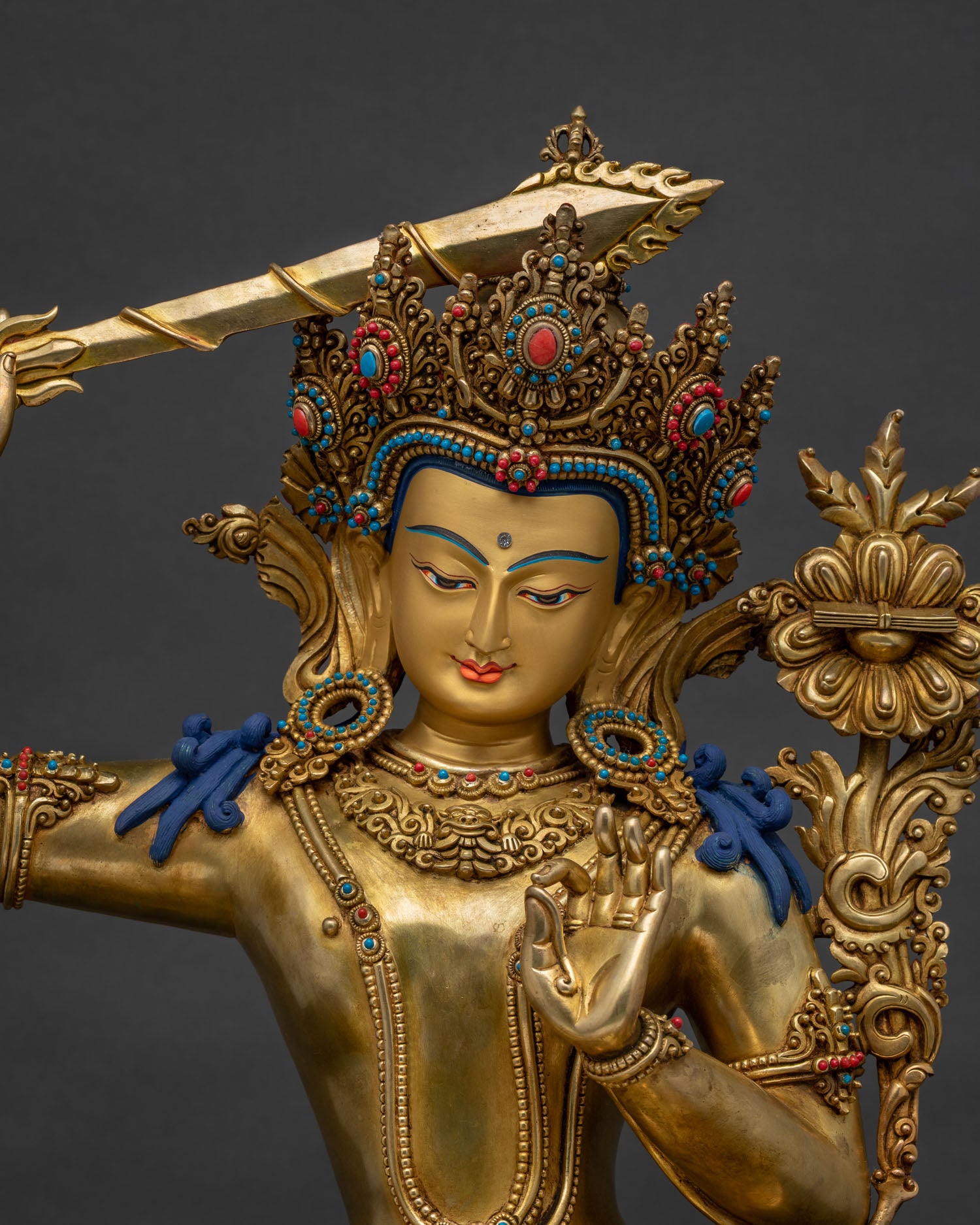 Close-up of handmade Manjushri statue, gold-gilded copper, Nepal Buddhist art
