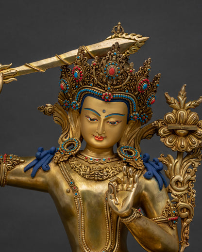 Close-up of handmade Manjushri statue, gold-gilded copper, Nepal Buddhist art