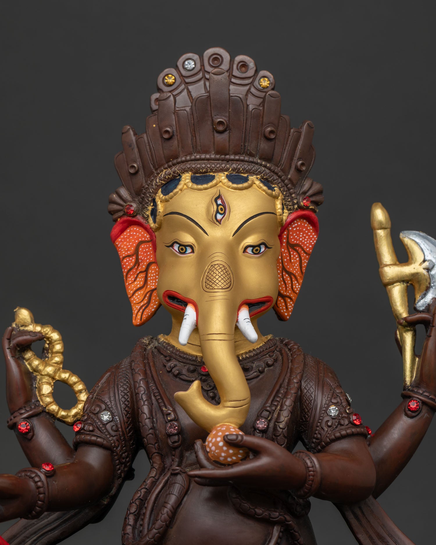 Close Up of Handmade Oxidized Copper Ganesh Statue with Gold Gilded Details