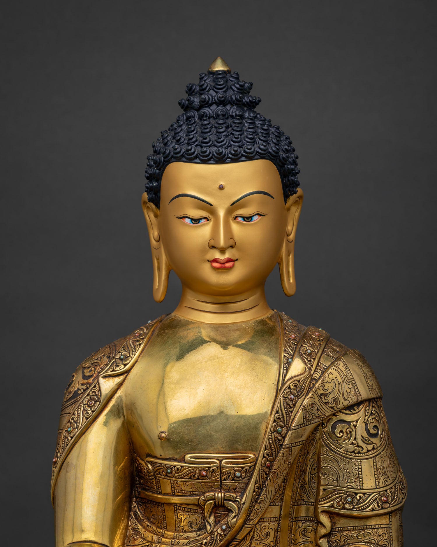Close up of handmade Shakyamuni Buddha statue showing 24K gold copper detail