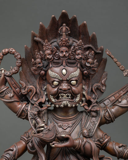 Close up of handmade Six Arm Mahakala Statue with oxidized copper and sacred ornaments
