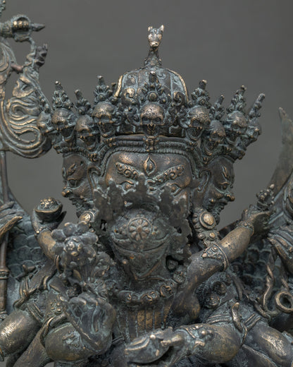 Close-up of Hayagriva bronze statue crown with skulls, horse head finial, and wrathful face detail