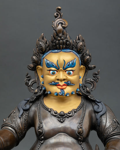 Close up of Jambhala statue with gold painted face and intricate Nepalese craftsmanship