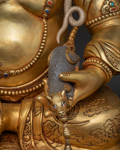 Close-up of jeweled mongoose spitting jewels in Dzambhala's hand