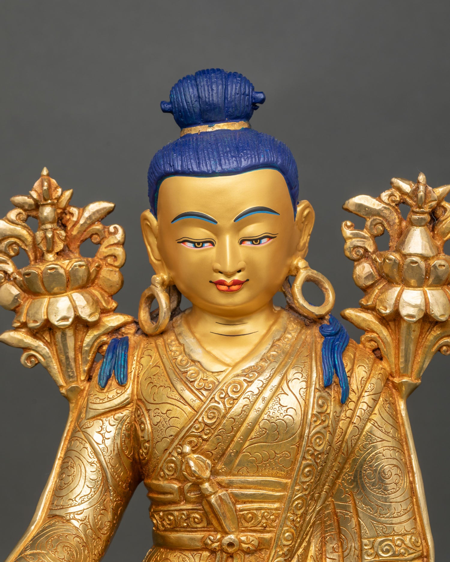 Close up of Jigme Lingpa face and robes with intricate floral motifs and scrollwork