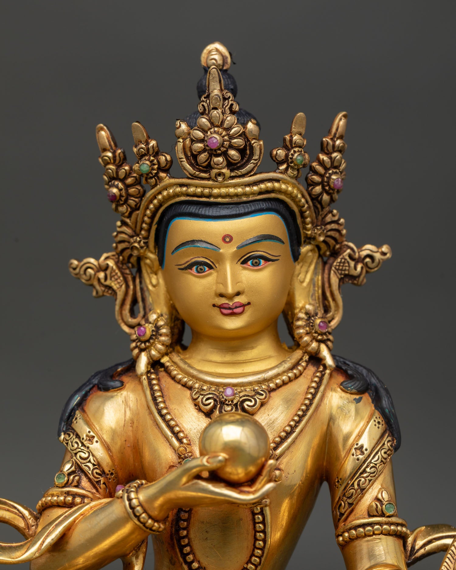 Close-up of Jizo Ksitigarbha Statue with chintamani jewel, gold-gilded copper Buddhist artwork