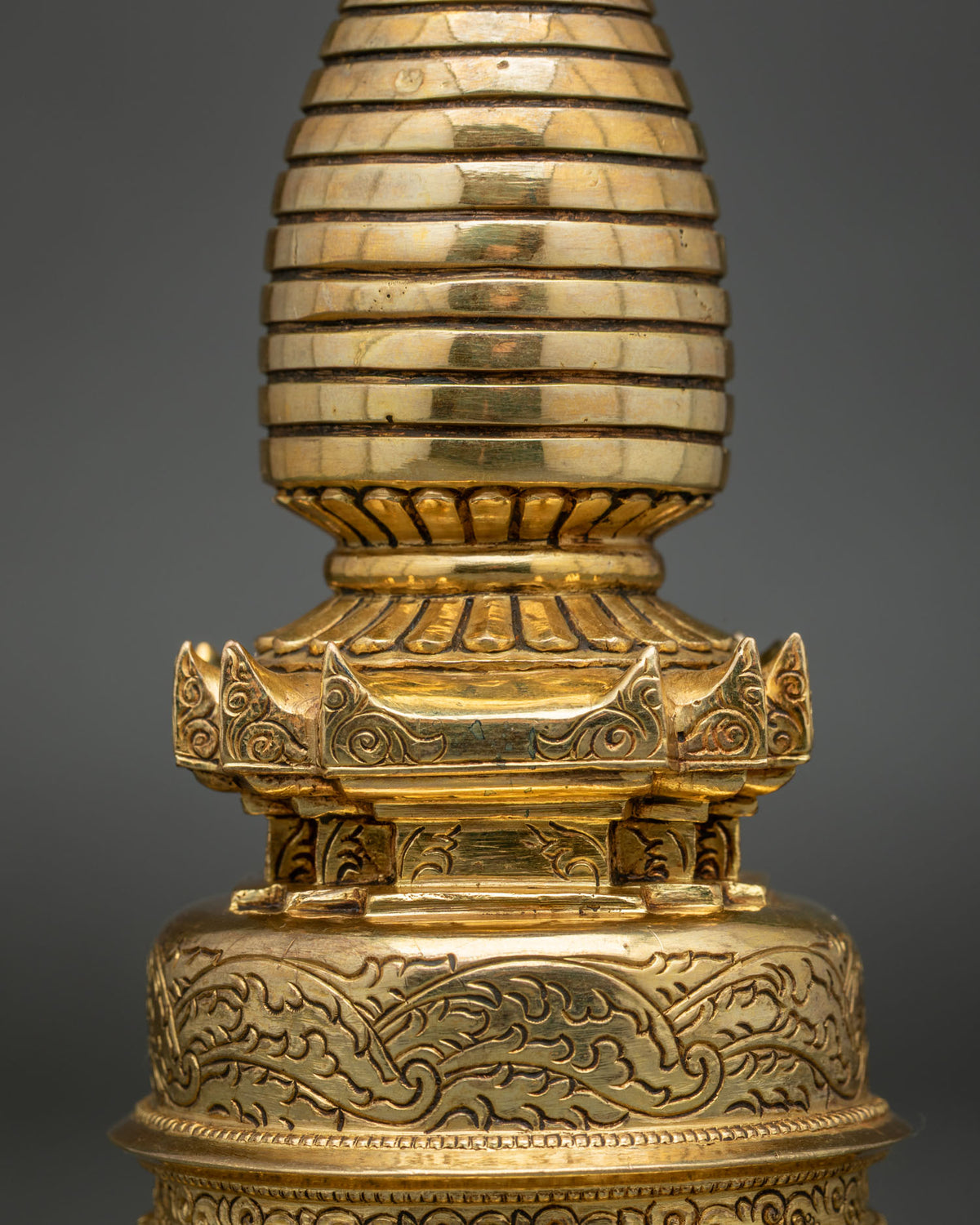 Close-up of Kadampa Stupa with intricate floral motifs and 24K gold plating