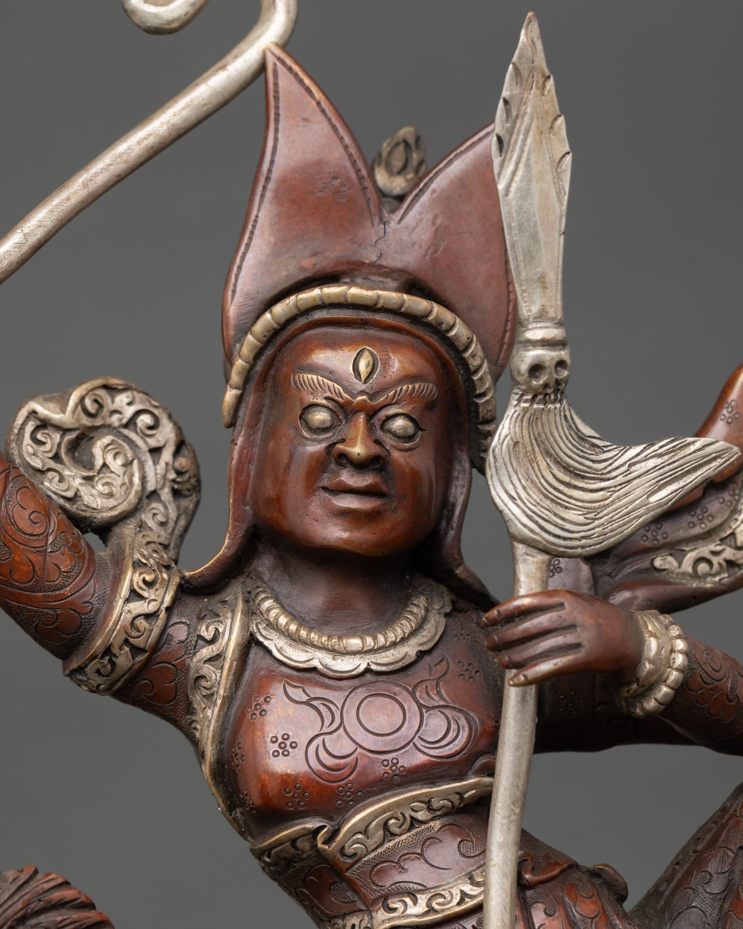 close-up of king gesar statue showing armor details and silver plated craftsmanship