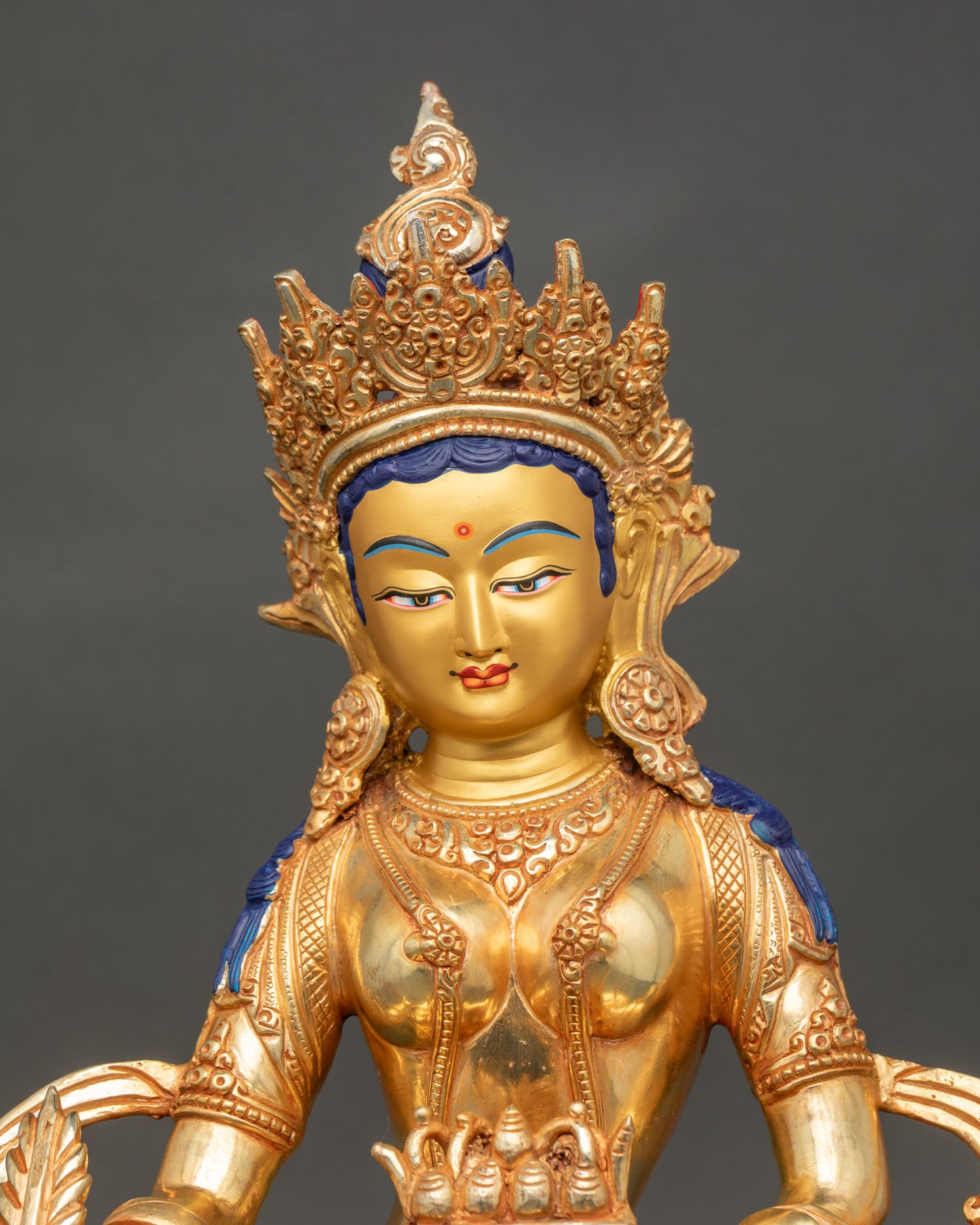 Close up of Kshitigarbha face gold painted details and intricate robe patterns