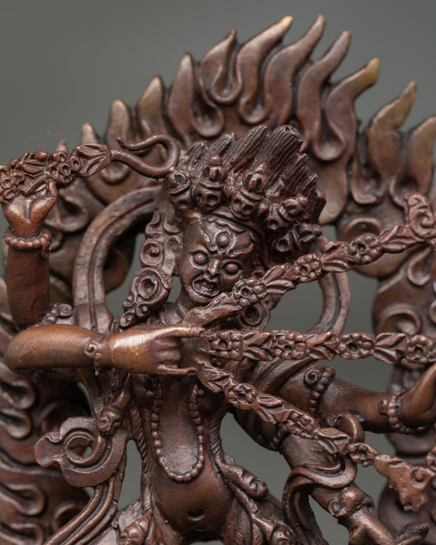 Close up of Kurukulla statue showing four arms sacred implements and detailed Himalayan craftsmanship