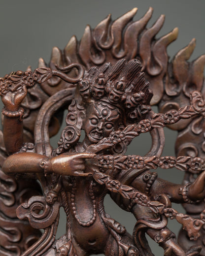 Close up of Kurukulla statue showing four arms sacred implements and detailed Himalayan craftsmanship