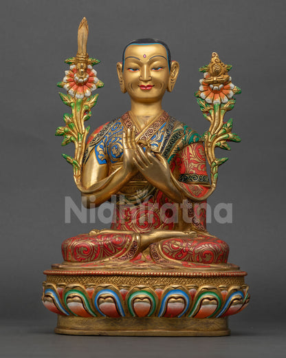 Close up of Lama Tsongkhapa statue with gold painted face and colorful traditional Tibetan Buddhist details