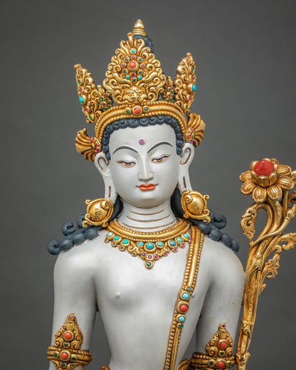 Close-up of Lokeshvara statue face with gold gilded five-jeweled crown and turquoise inlaid necklace