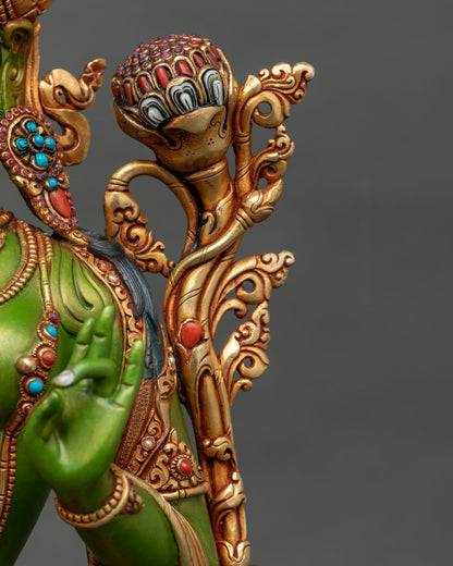 Close-up of lotus bud on gilded stem with coral and white inlays, Green Tara statue