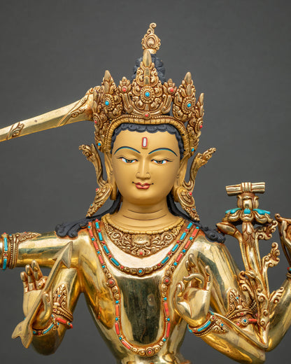 Close-up of Maha Manjushri statue with jeweled crown, flaming sword and utpala with turquoise inlays